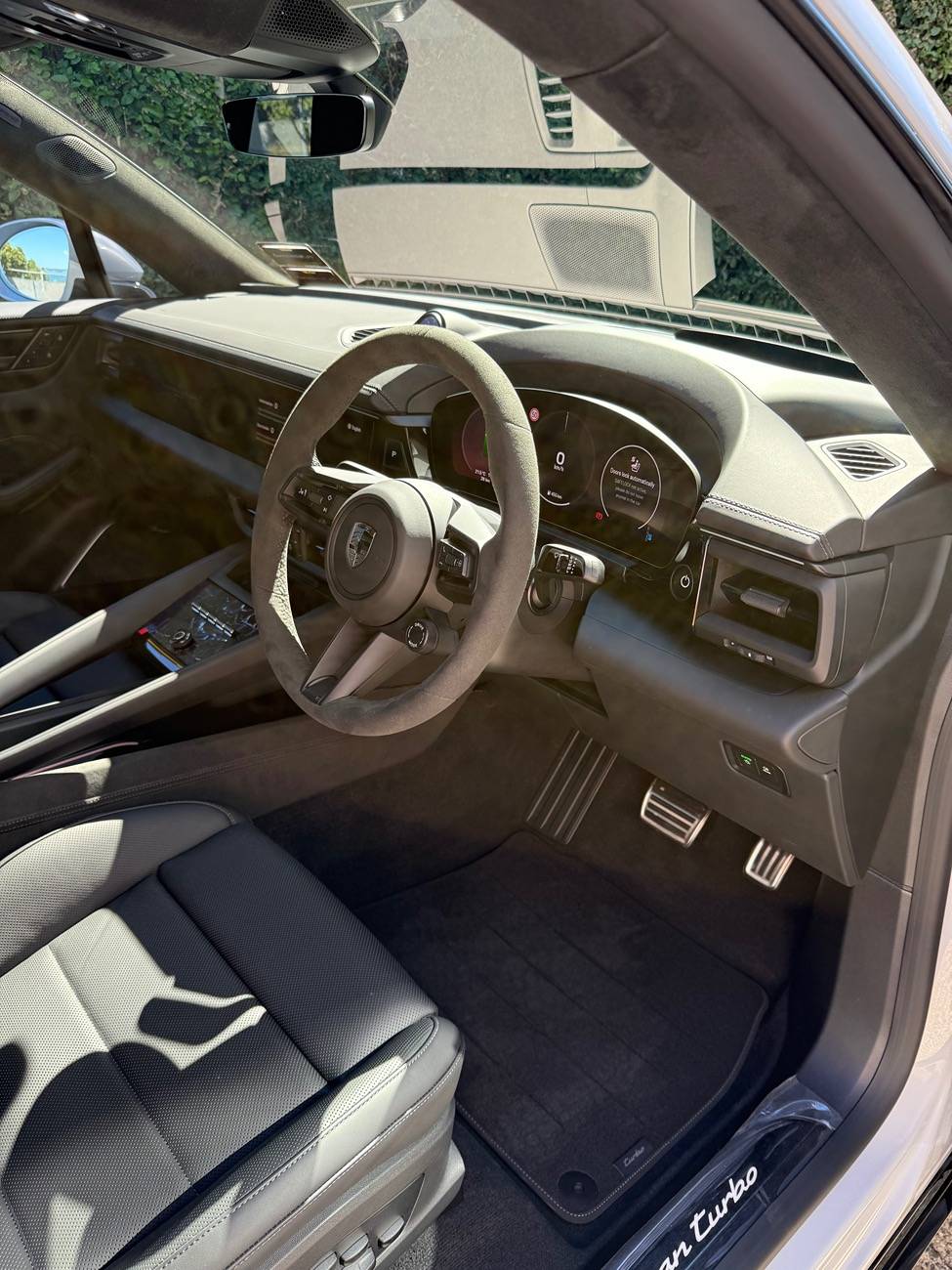 Electric Macan EV Photos: model logo on center armrest and race-tex center console frame IMG_4015