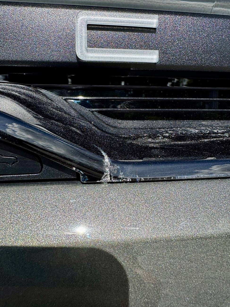 Electric Macan EV Cracks on black glass trunk trim IMG_5724