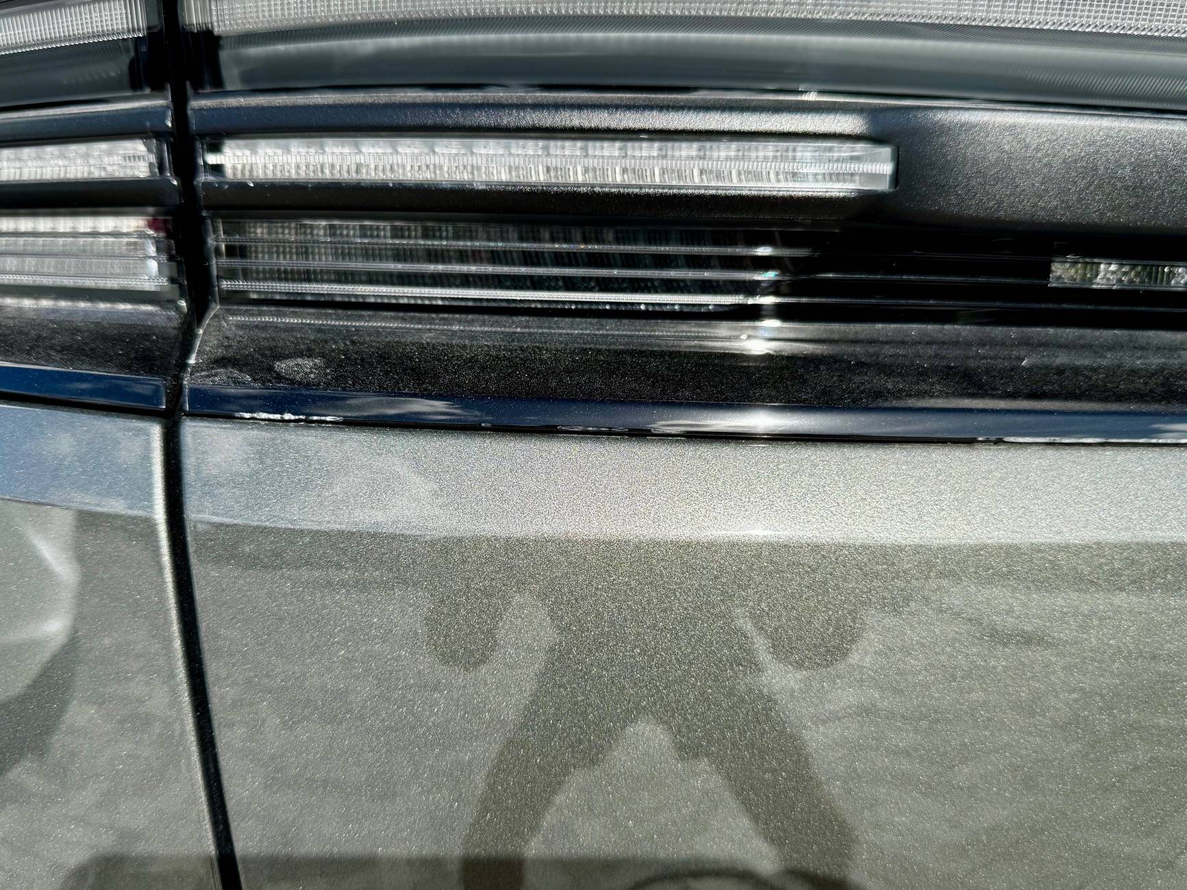 Electric Macan EV Cracks on black glass trunk trim IMG_5721