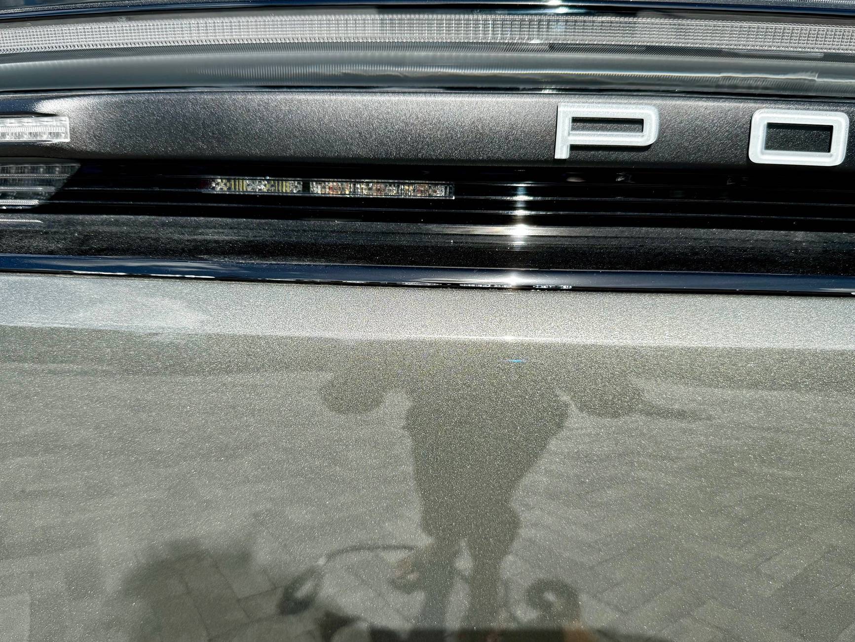 Electric Macan EV Cracks on black glass trunk trim IMG_5720