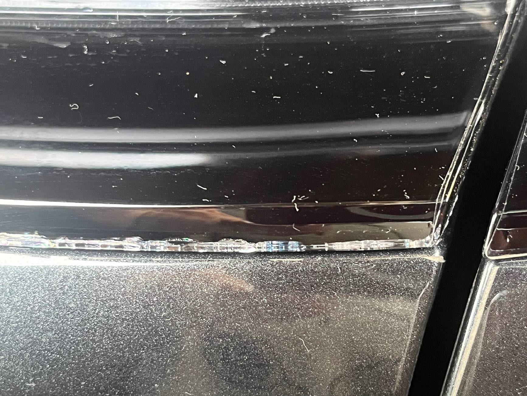Electric Macan EV Cracks on black glass trunk trim IMG_0226