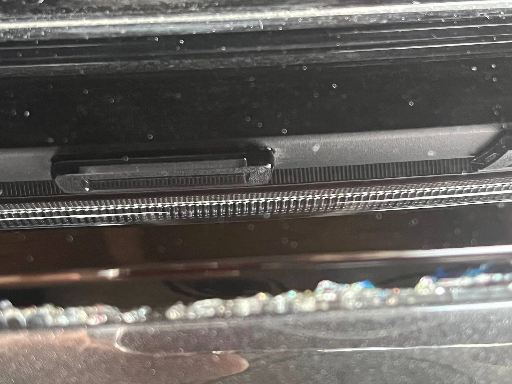 Electric Macan EV Cracks on black glass trunk trim IMG_0224