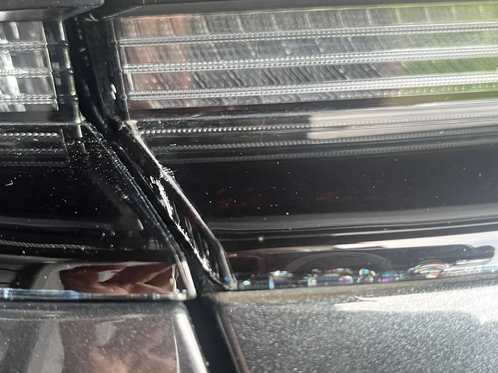 Electric Macan EV Cracks on black glass trunk trim IMG_0221
